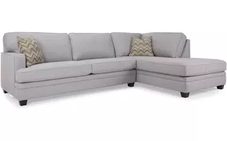 2696 - Sofa and chaise combo that puts comfort and lounging as its first priority. Semi attached back with water fowl encased in cotton twill makes for a cozy place to nestle.   So, kick off your shoes and stay awhile.