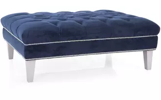 2734 - This expertly hand tufted Ottoman is a statement piece for any home. 7” Wood legs and optional nail studs give this ottoman an air of elegance. Can be used in a traditional or glamorous lifestyles depending on the fabric chosen.